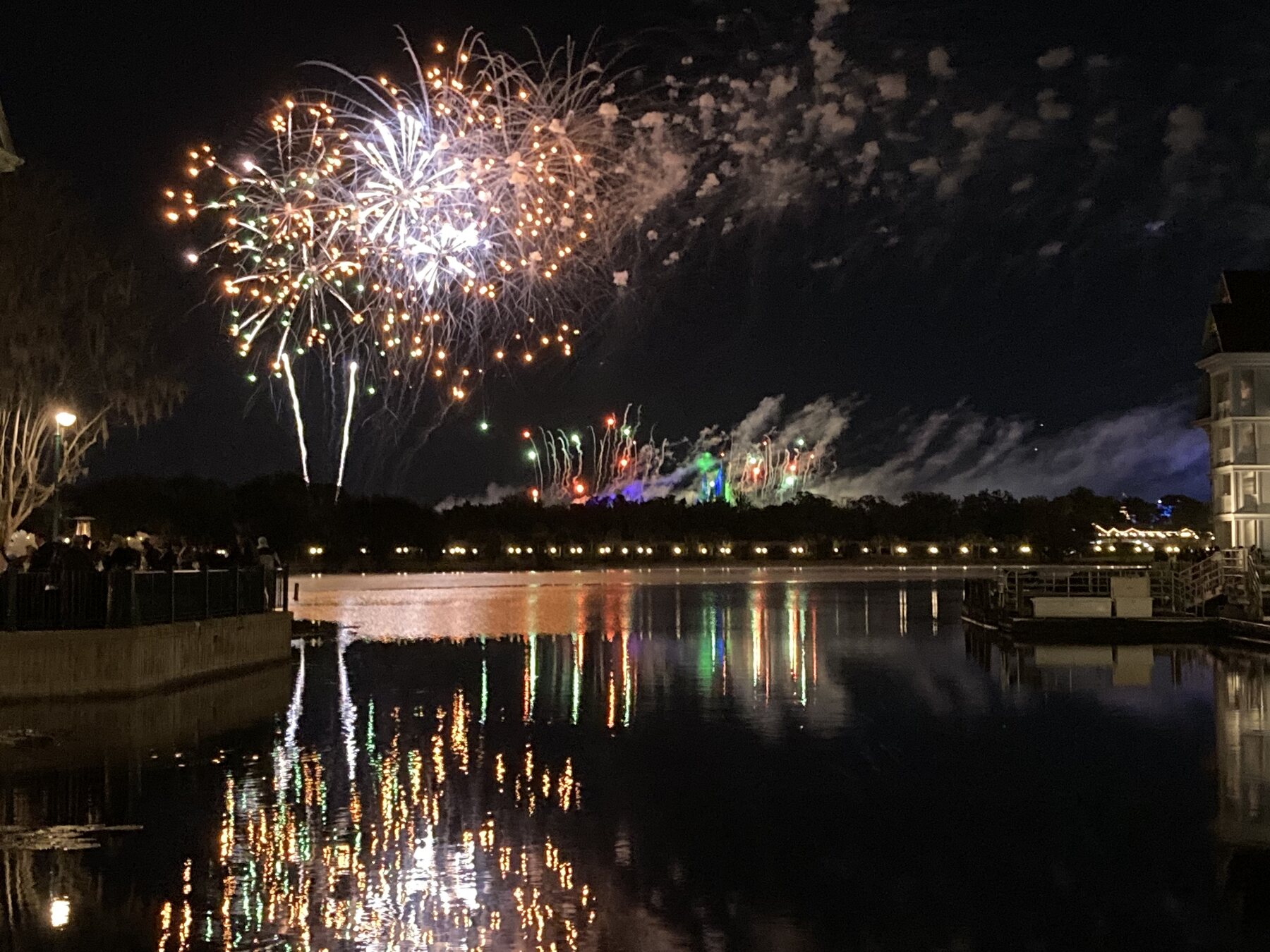 Fireworks reflected across a lake at Walt Disney World